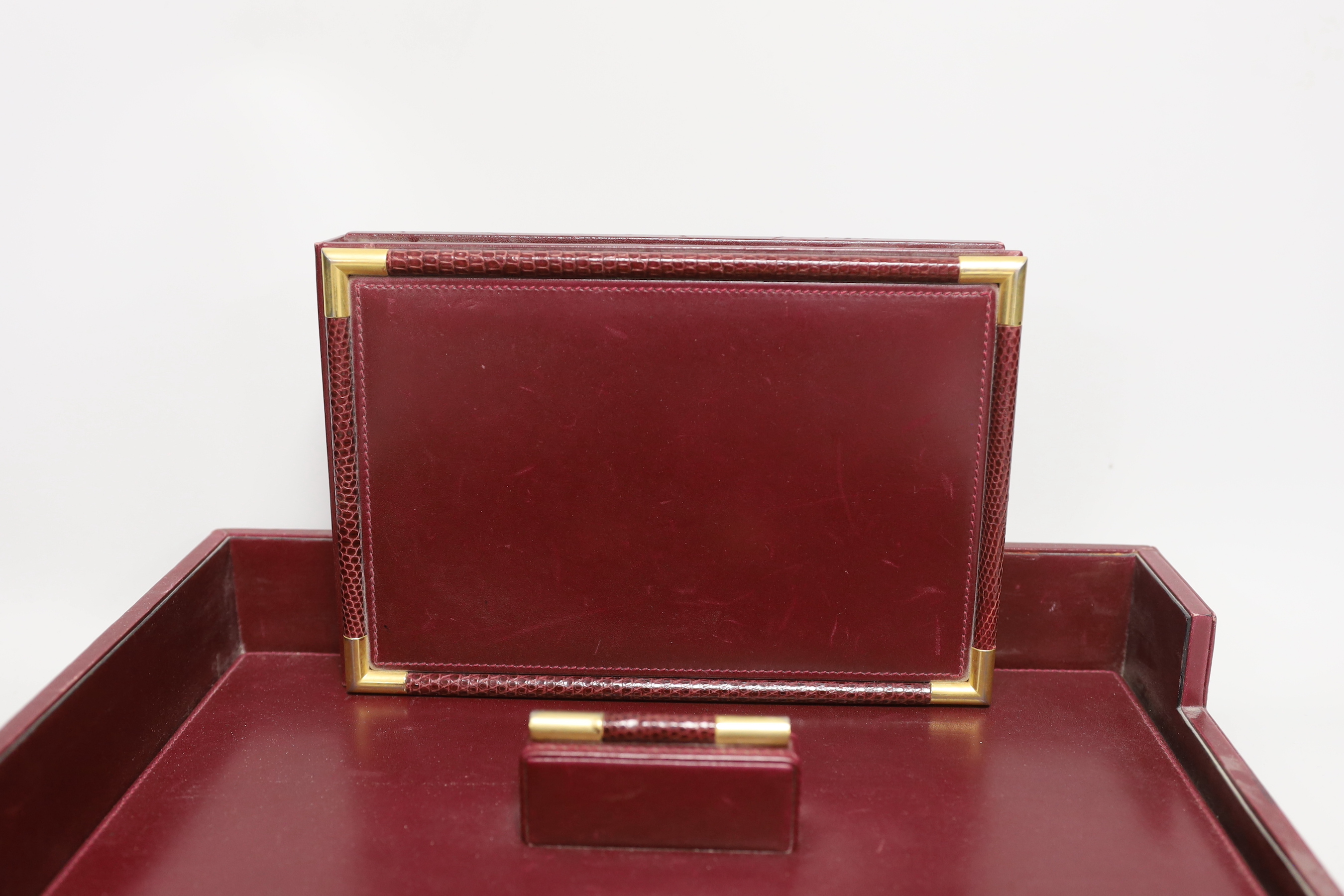 An Asprey red leather three piece desk set, tray 34.5cm long x 26cm wide, faux crocodile edges